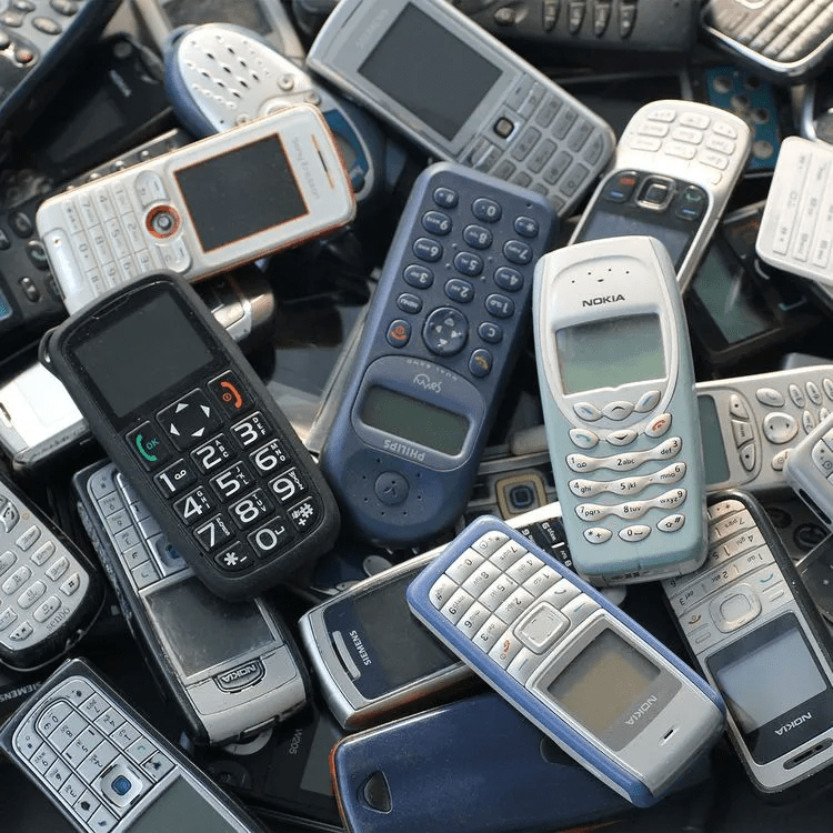 Number of old mobile phones with dial keypads on the floor